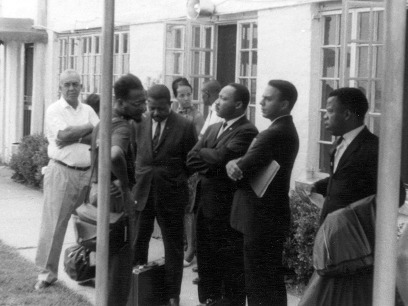 Civil rights leaders and workers gather at Greenwood Airport in Mississippi, July 1964. From left are Dewey Greene Sr., Mateo Suarez, the Rev. Ralph Abernathy Sr., Doris Derby, (unidentified man), the Rev. Martin Luther King Jr., Andrew Young Jr. and John Lewis. (Photo used with the permission of the Rev. Ed King, University Press of Mississippi and the Mississippi Department of Archives and History)
